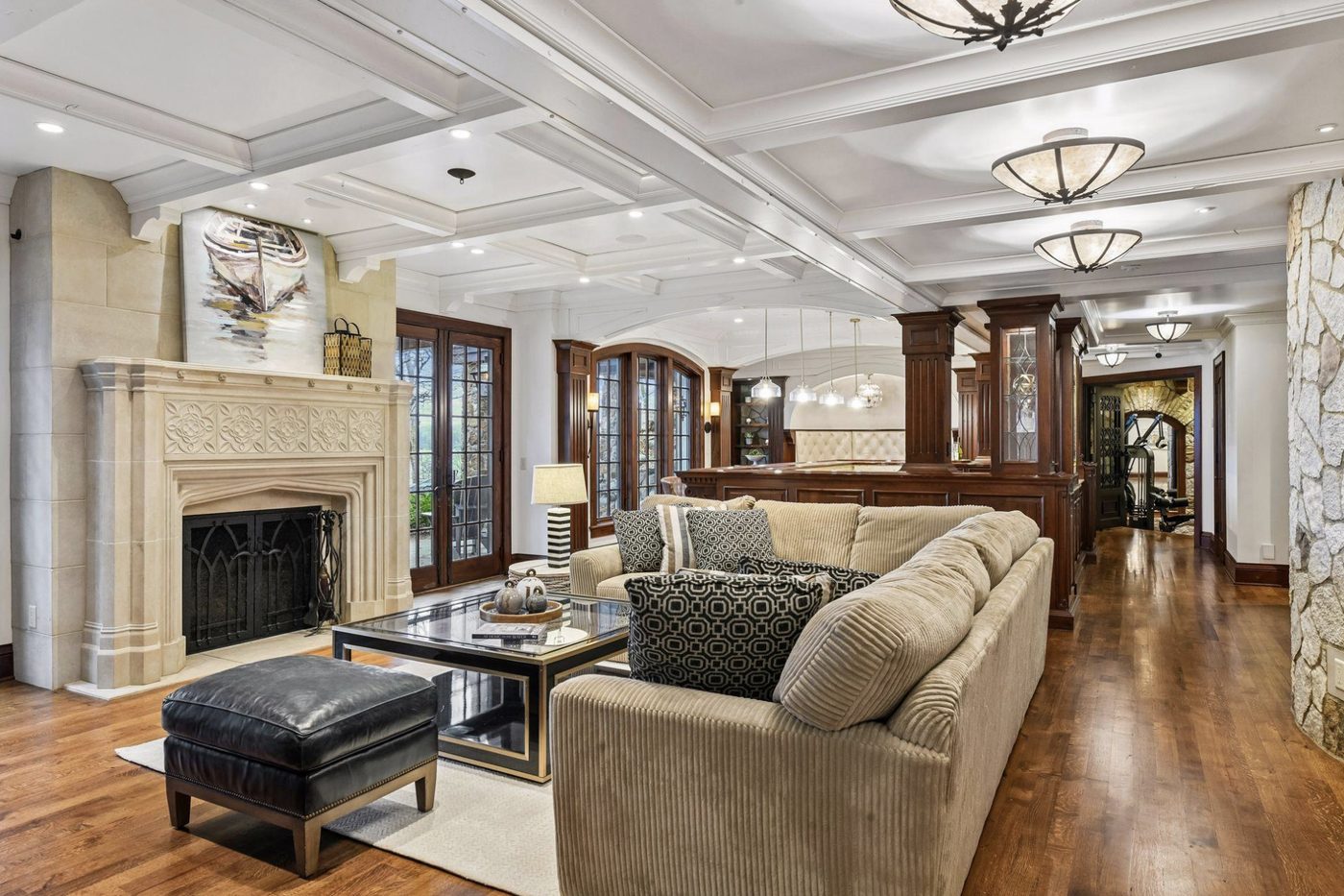 The lower level, lightened and restaged around the limestone fireplace